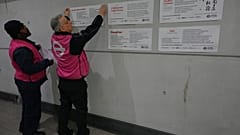 TFL ambassadors display poems at a gathering to celebrate 40 years of 'Poems on the Underground' in London, Friday, 30 Jan., 2026. (AP Photo/Kirsty Wigglesworth)