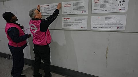 TFL ambassadors display poems at a gathering to celebrate 40 years of 'Poems on the Underground' in London, Friday, 30 Jan., 2026. (AP Photo/Kirsty Wigglesworth)