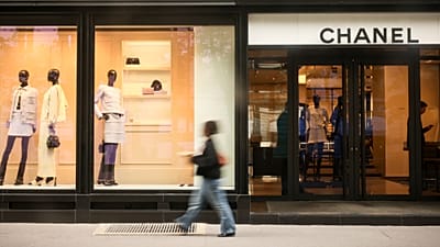 A woman walks past a Chanel shop, Monday, 28 July, 2025 in Paris.