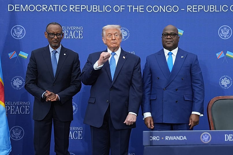 President Donald Trump stands with Rwanda's President Paul Kagame and DRC President Felix-Antoine Tshisekedi, Dec. 4, 2025, in Washington, DC.