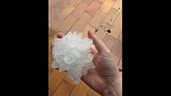A resident holds a giant hailstone after violent storms swept through France.