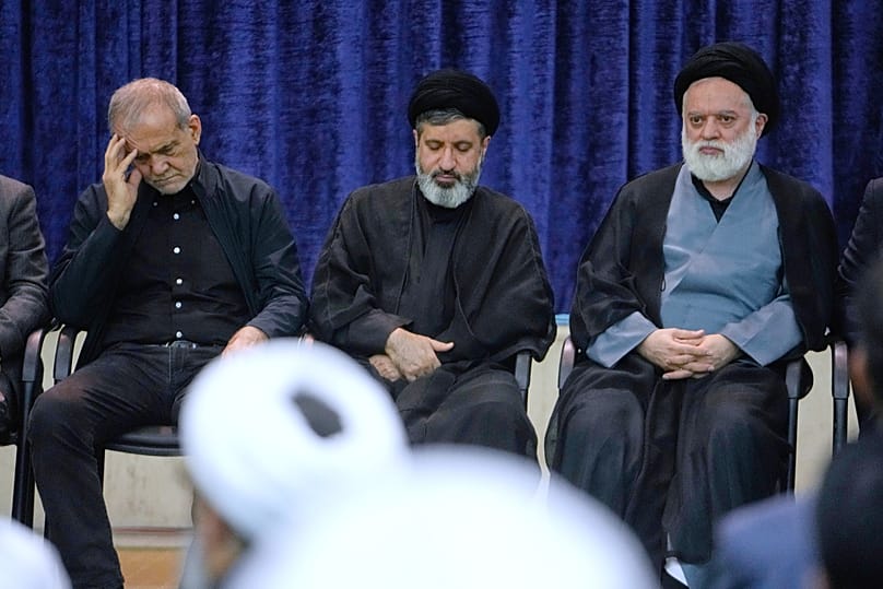 President Masoud Pezeshkian, left, sons of the late Supreme Leader Ayatollah Ali Khamenei, Masoud, center, and Mostafa, attend a ceremony to commemorate the late leader at the