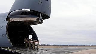 FILE- US Army carry team moves the flag-draped transfer case containing remains of Sgt. Kennedy Ladon Sanders, 24, of Waycross, Ga on Friday, Feb. 2, 2024. 