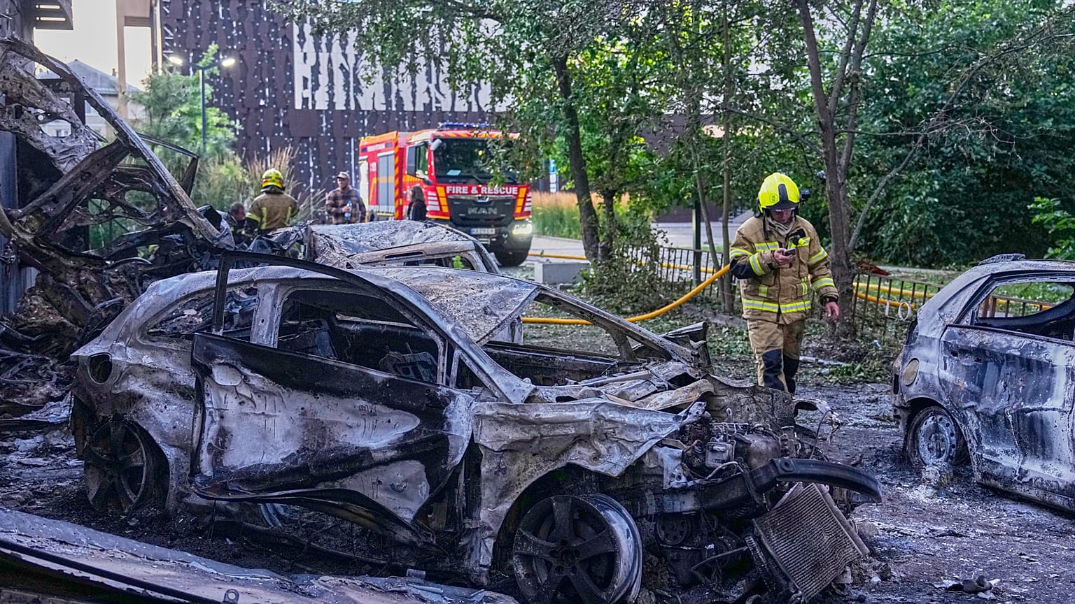A firefighter puts out a fire following a Russia missile attack in Kyiv