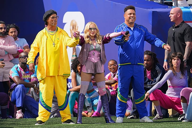 World at their feet: Ronaldinho, left, and Ronaldo stand with Madonna as she performs during the halftime show at the World Cup final between Spain and Argentina in New Jersey