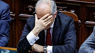 Italy’s Interior Minister Matteo Piantedosi holds his head as he addresses the parliament in Rome, Thursday, Feb. 29, 2024