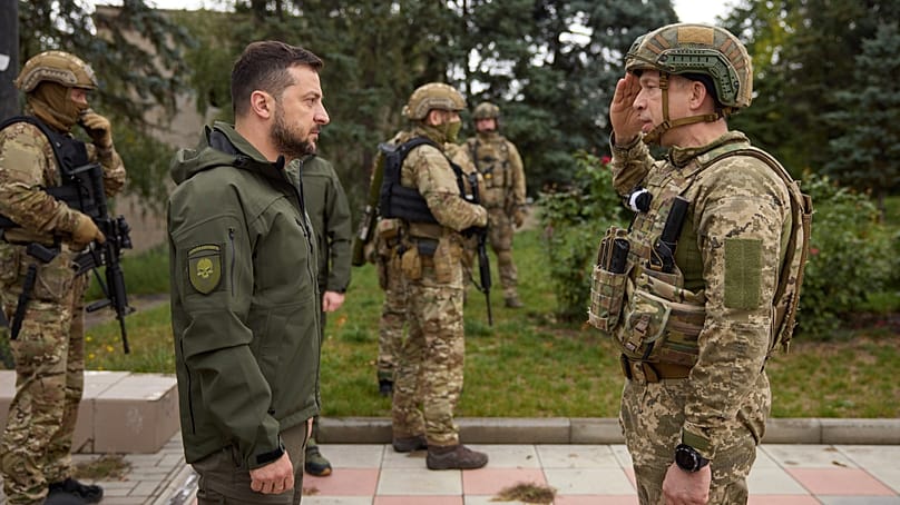 FILE: Volodymyr Zelenskyy, left, listens to Gen. Oleksandr Syrskyi's report during his visit in Izium, Kharkiv region, Ukraine, Wednesday, Sept. 14, 2022. 
