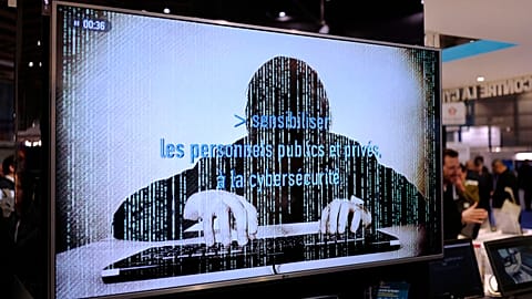 FILE - A television screen reads "Alerting public organizations and people to cybersecurity" at the International Cybersecurity forum in Lille, France, Jan. 2, 2018