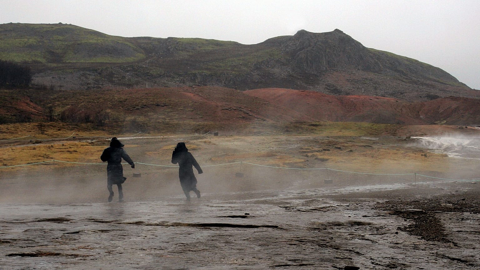  FILE ** In this Feb. 22, 2006 file photo tourists brave the weather to walk around the hot springs area at the site of Geysir, Iceland. (AP Photo/Kirsty Wigglesworth, File)