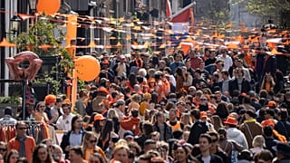 أشخاص يرتدون اللون البرتقالي يحتفلون بـ"يوم الملك" في أمستردام، هولندا، الخميس 27 نيسان 2023، خلال الاحتفال بعيد الميلاد السادس والخمسين للملك فيليم ألكسندر من بيت
