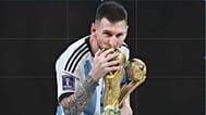 Lionel Messi kisses the FIFA World Cup after Argentina beat France at the 2022 final in Saudi Arabia 