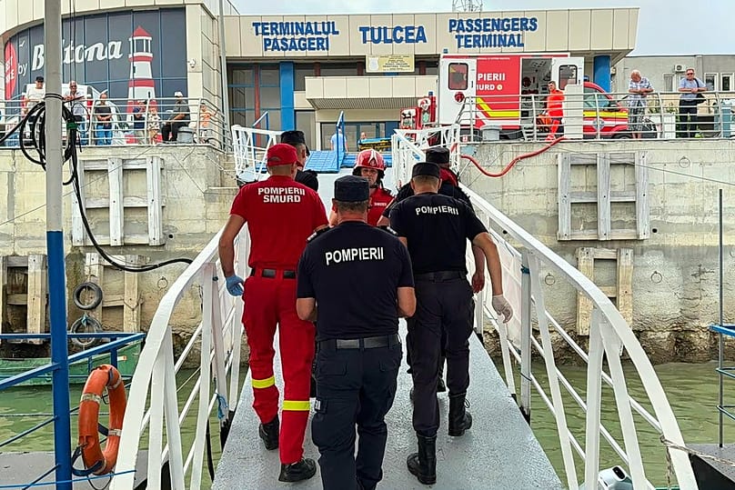 Rescuers and paramedics walking at a docking area in Tulcea, Romania, after an LPG tanker ship sailing towards a Ukrainian port caught fire, Tuesday, July 21, 2026, 
