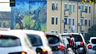 Cars in a traffic jam at a cross roads in Rome.