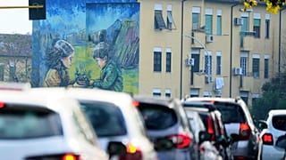 Cars in a traffic jam at a cross roads in Rome.