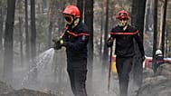 Firefighters tackle a wildfire in the region of the Fontainebleau forest, south of Paris, France, Tuesday, July 14, 2026. 