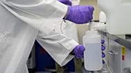 Logan Feeney pours a PFAS water sample into a container for research, Wednesday, April 10, 2024, at a U.S. Environmental Protection Agency lab in Cincinnati.