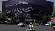 مرت مركبات بجوار لوحة إعلانية في ساحة الثورة الإسلامية وسط طهران تُظهر الرئيس الأميركي دونالد ترامب مستلقياً على ما يبدو أنه نعش وتحمل عبارة "سنقتل ترامب".