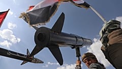FILE: A Houthi supporter chants slogans as he carries a rocket replica during a rally in Sana'a, Yemen, following Israeli airstrikes in Sanaa, 26 September 2025