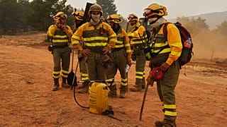 Forest rangers take a break near Condemios de Arriba, Guadalajara, Spain, Wednesday, July 22, 2026, as crews battle a major wildfire.