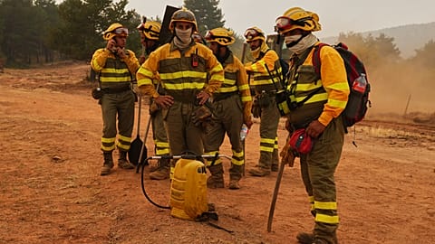 Forest rangers take a break near Condemios de Arriba, Guadalajara, Spain, Wednesday, July 22, 2026, as crews battle a major wildfire.