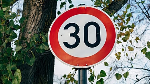 A red and white speed limit sign showing 30mph. 