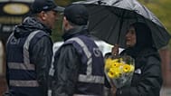 A woman carrying flowers attends a vigil for the victims of the attack at Heaton Park Hebrew Congregation synagogue in Manchester, England, Friday, 3 October 2025.