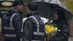 A woman carrying flowers attends a vigil for the victims of the attack at Heaton Park Hebrew Congregation synagogue in Manchester, England, Friday, 3 October 2025.