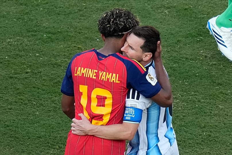 Spain's Lamine Yamal (19) and Argentina's Lionel Messi (10) embrace after during the World Cup final soccer match between Spain and Argentina in East Rutherford, N.J.