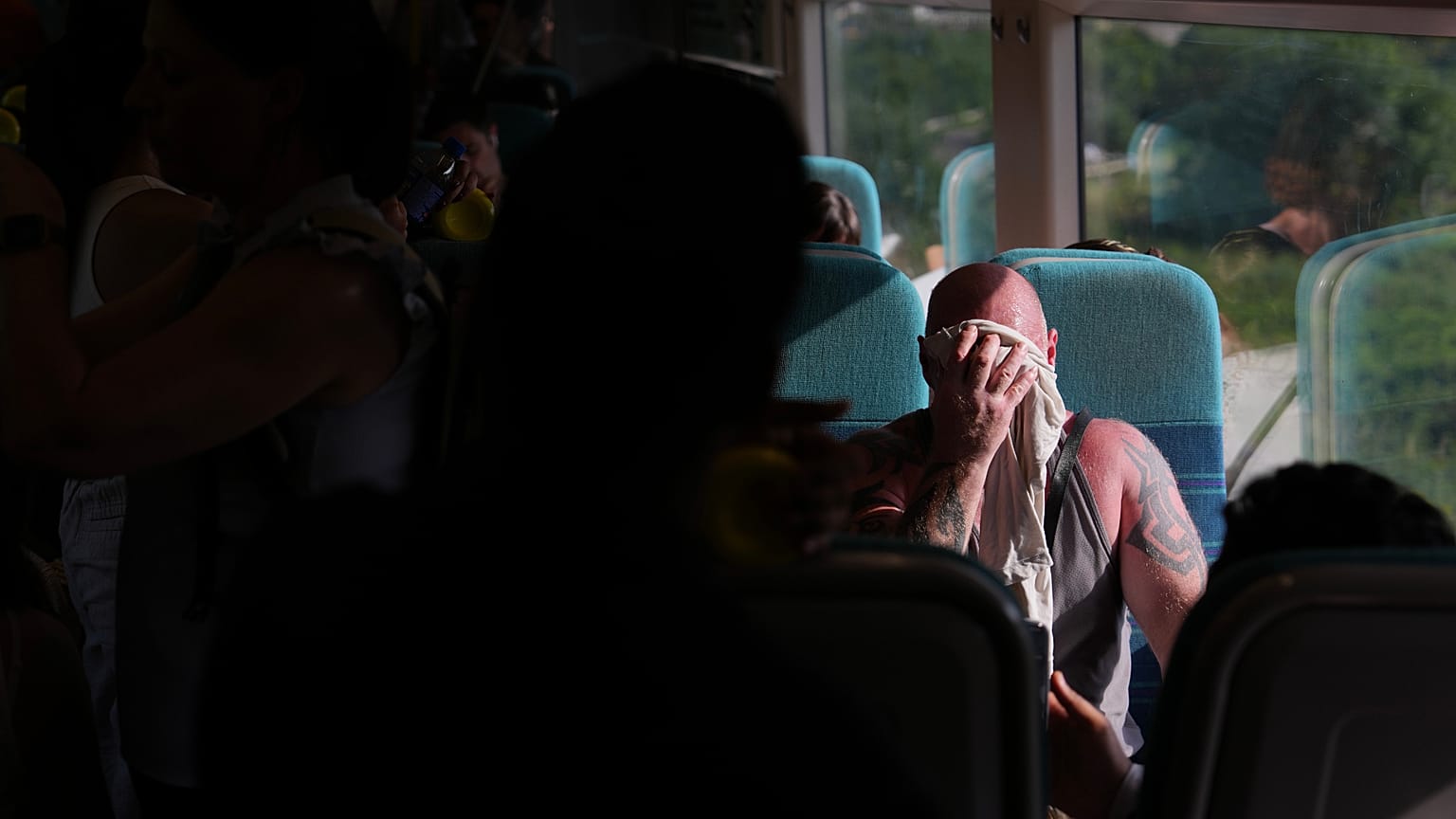 Ein Mann in einem Zug in London wischt sich Schweiß vom Gesicht, 24. Juni 2026 