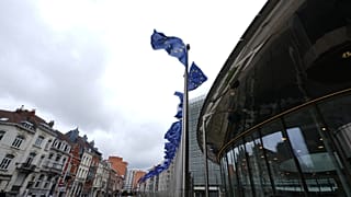 FILE - European Union flags flap in the wind outside EU headquarters in Brussels, prior to an announcement regarding Google. July 23, 2026.