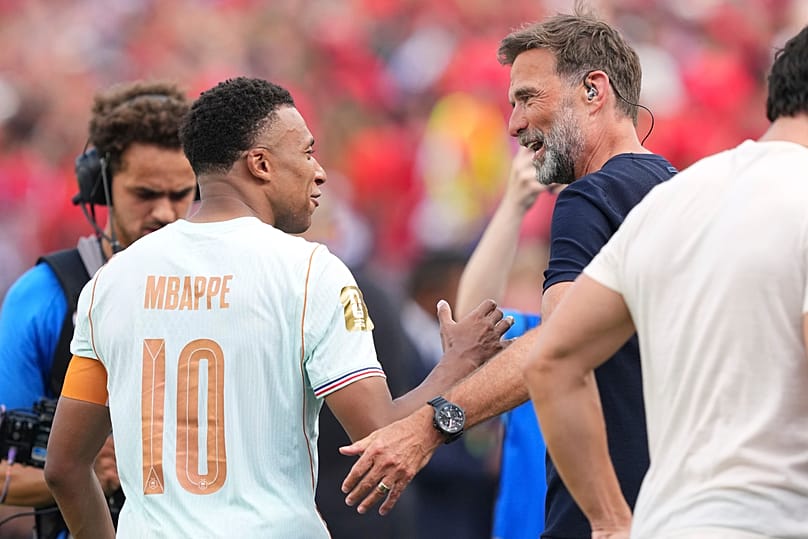 Former Liverpool coach Jürgen Klopp congratulates France's Kylian Mbappe (10) after France defeated Morocco in the World Cup quarterfinal soccer match.