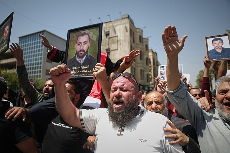People celebrate after a Syrian court sentenced Atef Najib, a cousin of ousted President Bashar Assad, to death, Damascus, Syria, Aug. 11, 2026