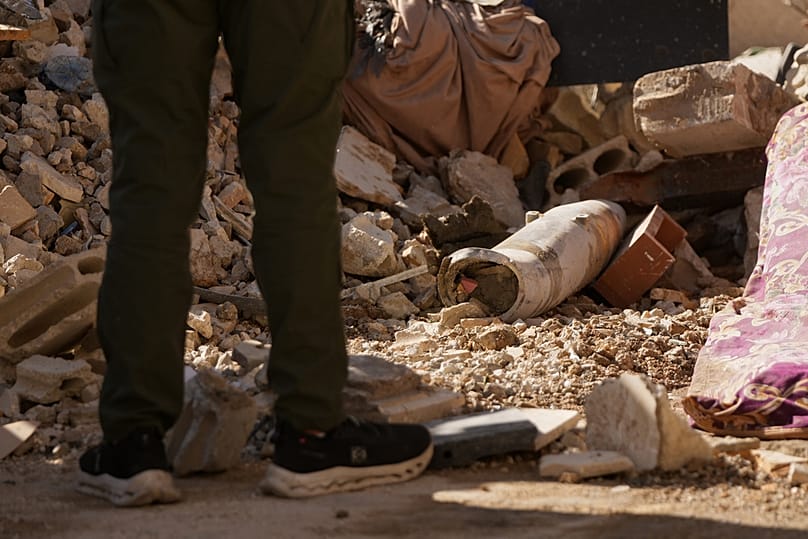 A man stands next to an unexploded missile at the site where an Israeli airstrike hit a building in Dahiyeh, Beirut's southern suburb, Lebanon, Sunday, June 7, 2026. 