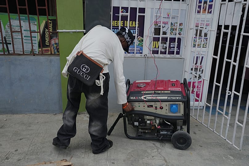 A worker starts a generator outside the printing shop of Oluwatosin Awodunmila and her husband in Lagos, Nigeria, on Friday, June 5, 2026. 