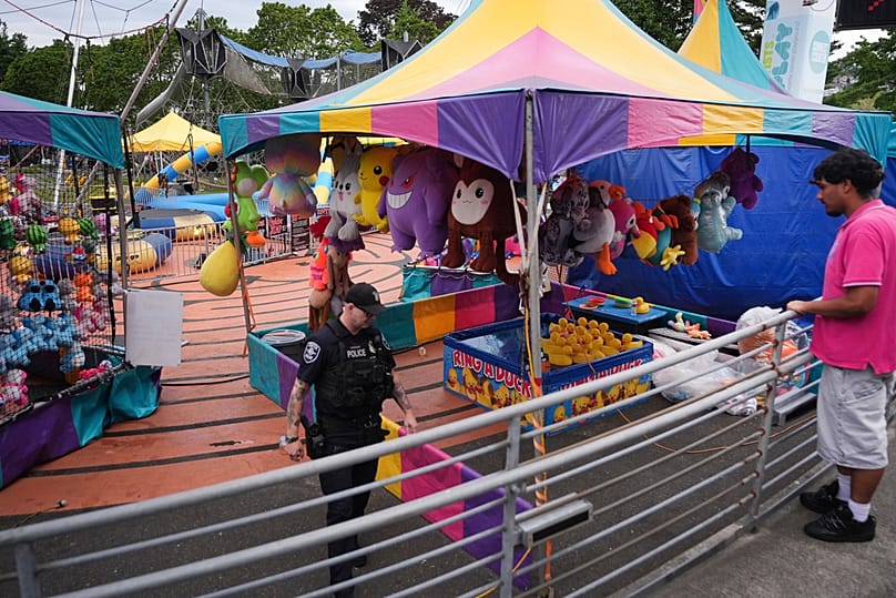 A police officer responds after a shooting at Seattle Center during the Bite of Seattle food festival Sunday, July 26, 2026, in Seattle, Washington