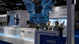 FILE - A worker at the booth for Chinese DRAM producer ChangXin Memory Technologies, also known as CXMT, waits for visitors at the 21st China International Semiconductor Expo.