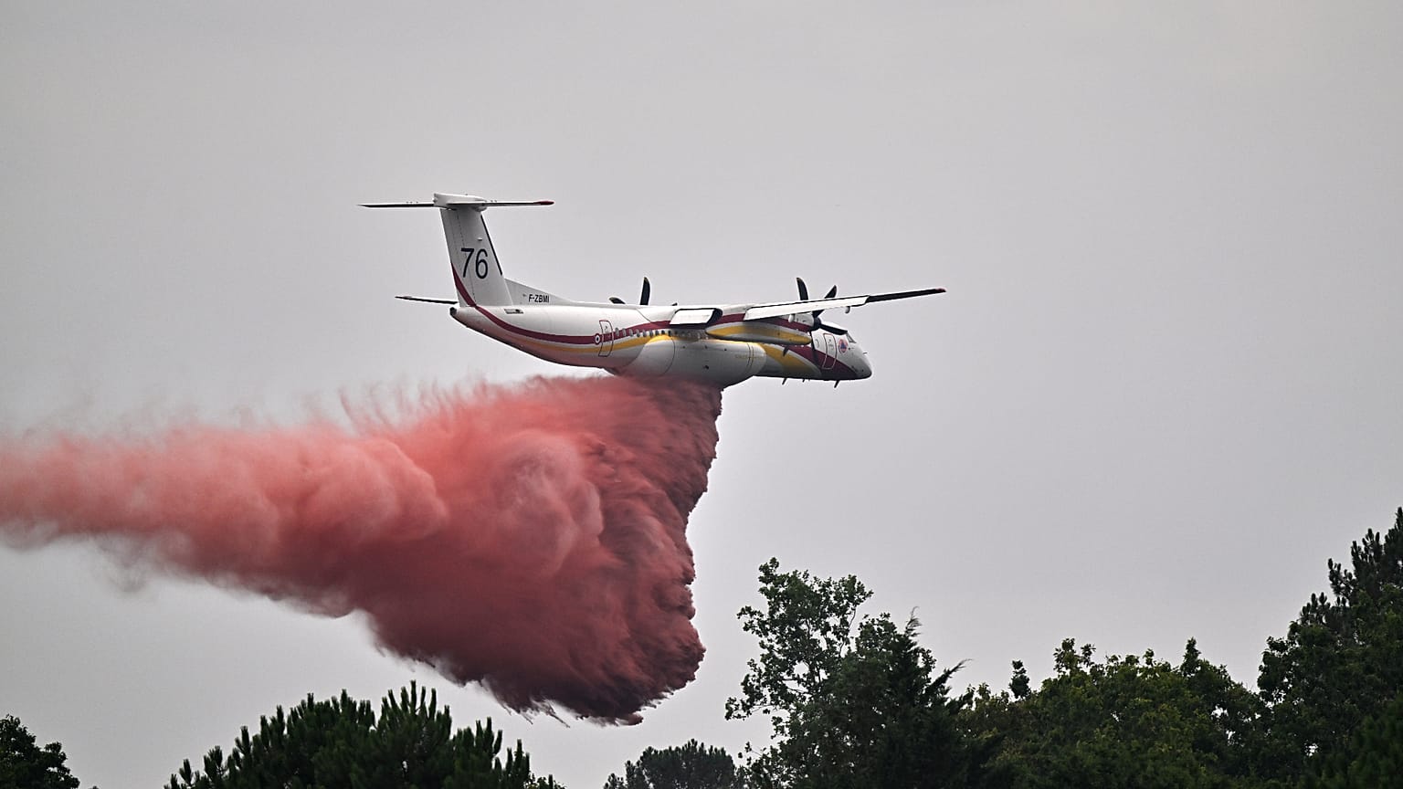A De Havilland Canada DHC-8-400 Dash 8 operated by the French civil defense agency drops fire retardant as wildfires rage near Marcheprime, outside Bordeaux, France, July 27.