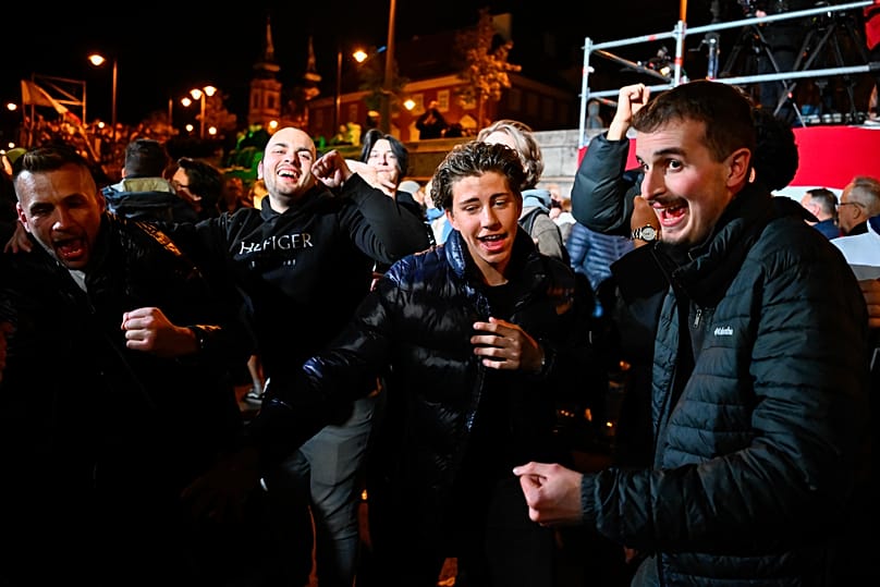 People celebrate in the streets following the announcement of the partial results of the parliamentary election, in Budapest, Hungary, Sunday, April 12, 2026. (AP Photo/Denes 