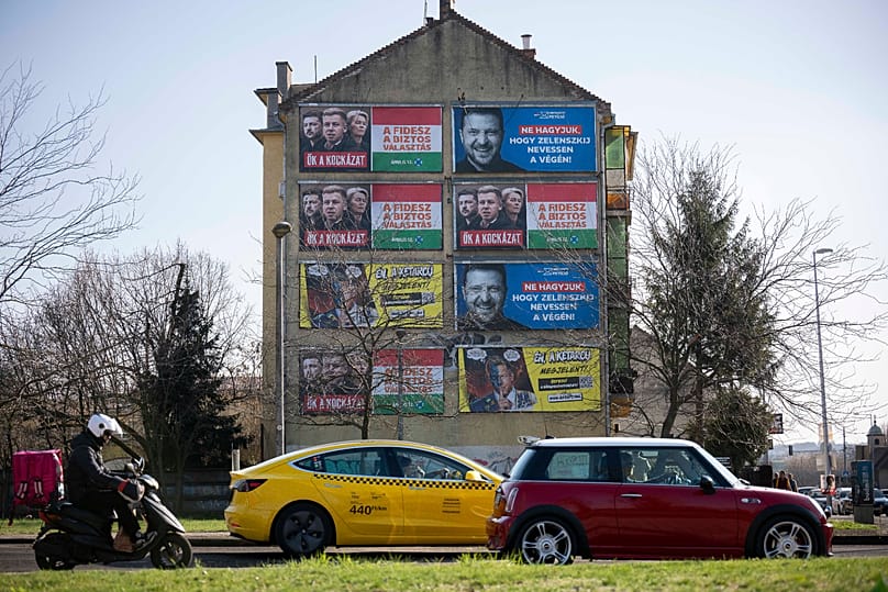 Campaign posters are displayed on a wall in Budapest, Hungary, on Saturday, March 14, 2026, ahead of the April 12 parliamentary election. (AP Photo/Denes Erdos)