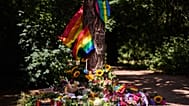 Flowers and rainbow flags placed at a tree in Tiergarten Park after Pride March car attack in Berlin, Germany, Monday, July 27, 2026.