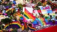 Flowers and rainbow flags placed in front of the Brandenburg Gate commemorating the victims of a car attack on Saturday's Pride March in Berlin, Germany, Monday, July 27, 2026
