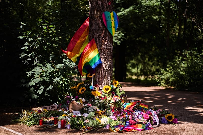 Flowers and rainbow flags placed at a tree in the Tiergarten Park near the scene where a car rammed into people after Saturday's Pride March in Berlin, Germany, July 27, 2026.