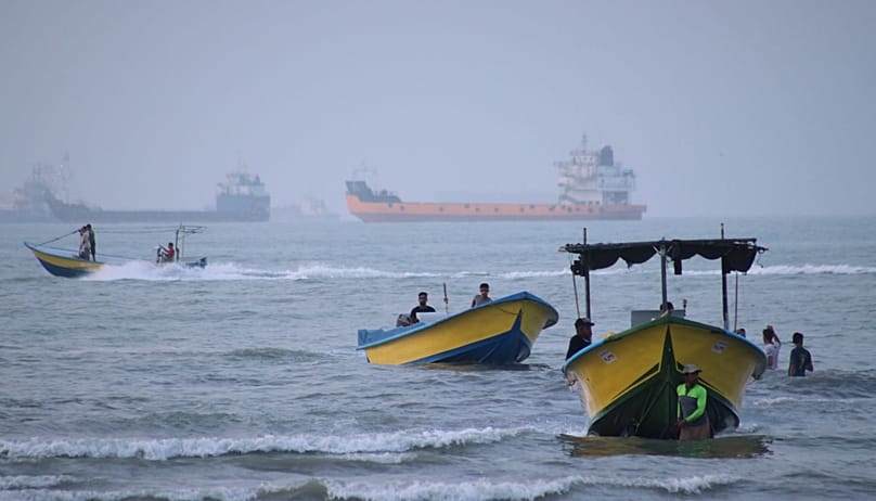 Small boats line the shore as cargo ships and other commercial vessels appear anchored in the Strait of Hormuz off Bandar Abbas, Iran, Monday, July 27, 2026. (Razieh Poudat/IS