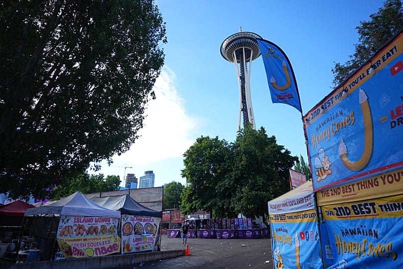 The US flag flies at half staff at the Space Needle as cleanup continues the day after a shooting at Seattle Center during a food festival, Monday, July 27, 2026