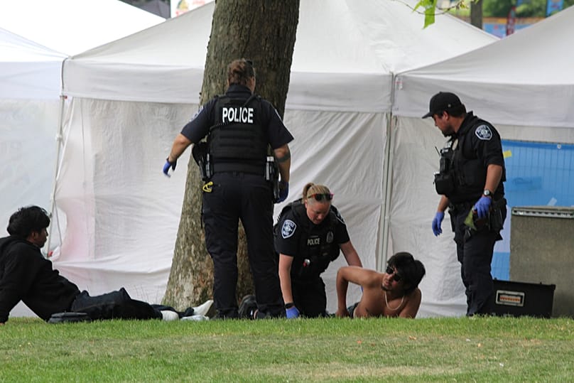 Police attend to a person after a shooting at Seattle Center during the Bite of Seattle food festival Sunday, July 26, 2026, in Seattle, Washington