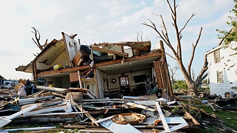 Destroços acumulam-se em frente a uma casa danificada após a passagem de um tornado, segunda-feira, 27 de julho de 2026, em Menasha, Wisconsin