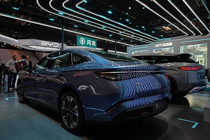 Visitors chat as car models are displayed at the Auto China 2026, in Beijing, Saturday, 25 April 2026.