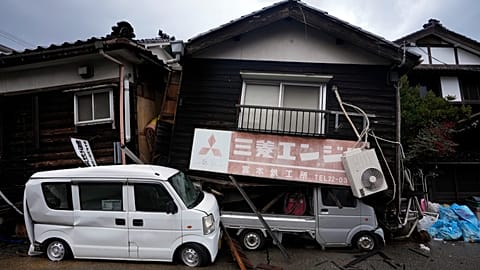 Se ven vehículos siniestrados y casas derrumbadas en Wajima, Japón, el domingo siete de enero de 2024, tras el potente terremoto y las alertas de tsunami.