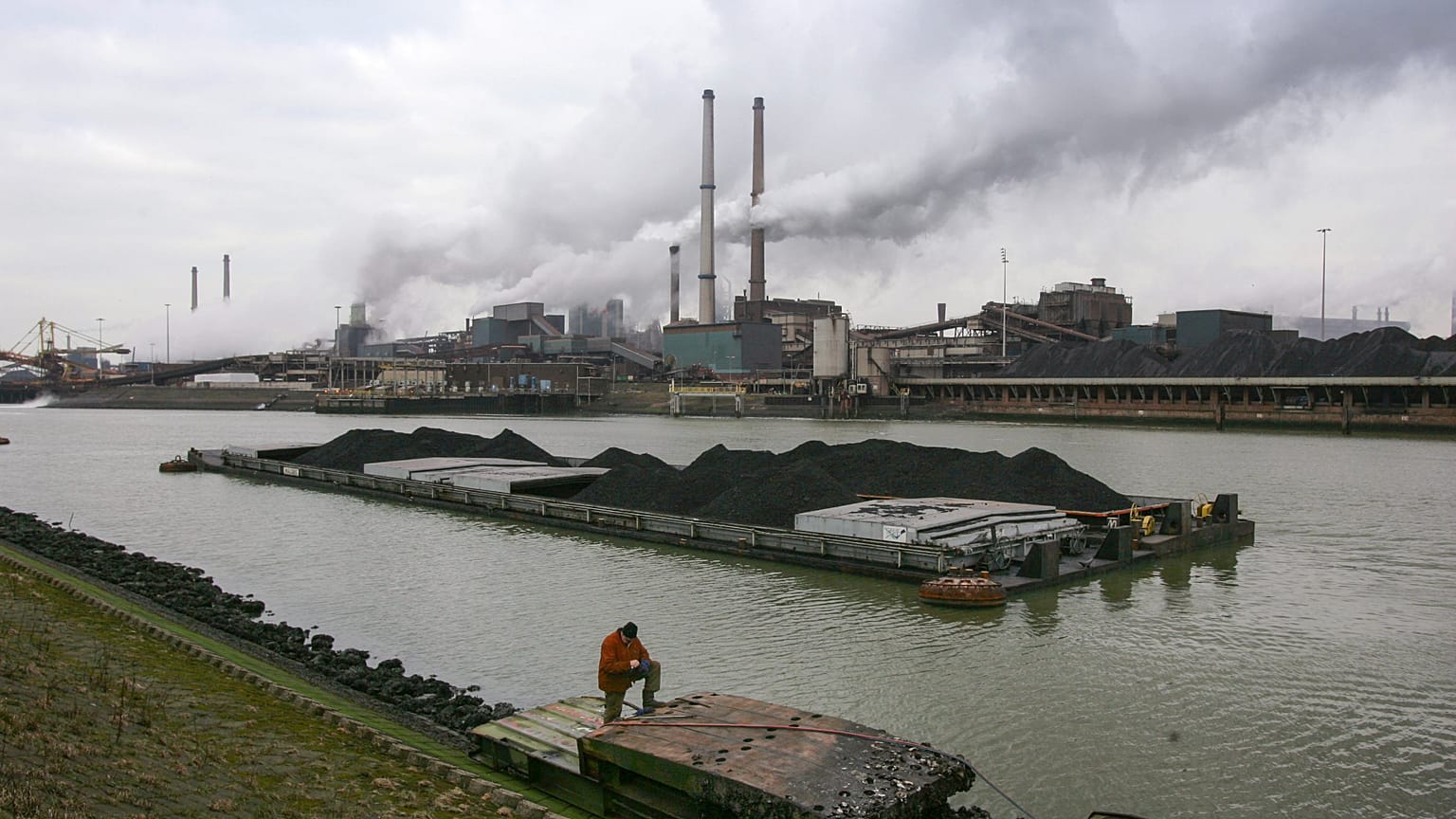 A worker is seen on a pontoon near the former Corus, and current Tata steel factory, background, in IJmuiden, Netherlands, on Tuesday Jan. 30, 2007. 