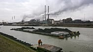 A worker is seen on a pontoon near the former Corus, and current Tata steel factory, background, in IJmuiden, Netherlands, on Tuesday Jan. 30, 2007. 